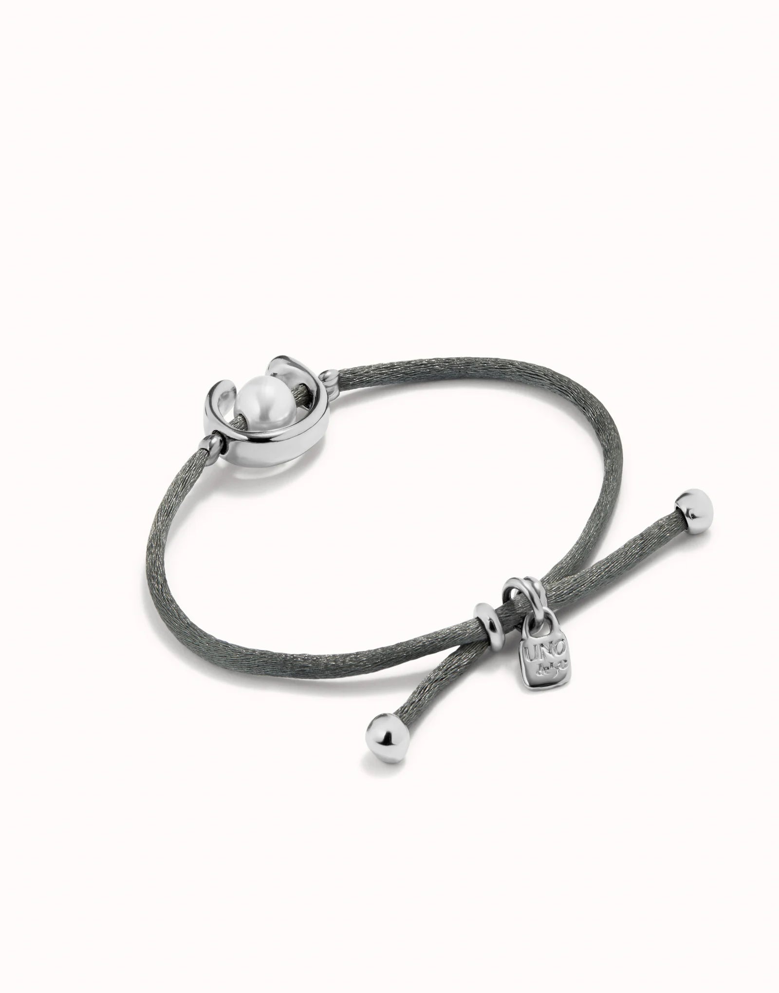 UNO DE 50 - Pulsera de hilo negroso con perla shell fornitura bañada en plata de ley.