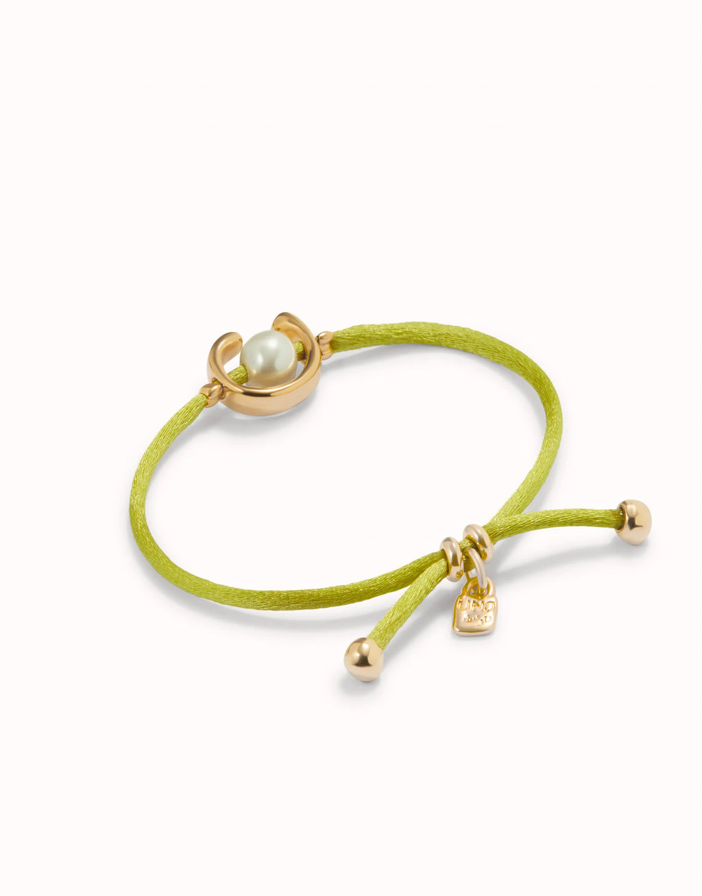 UNO DE 50 - Pulsera de hilo lima con perla shell fornitura bañada en oro 18k.