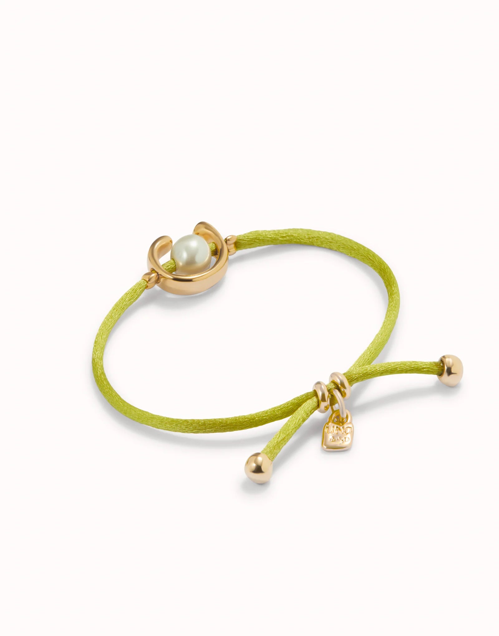 UNO DE 50 - Pulsera de hilo lima con perla shell fornitura bañada en oro 18k.